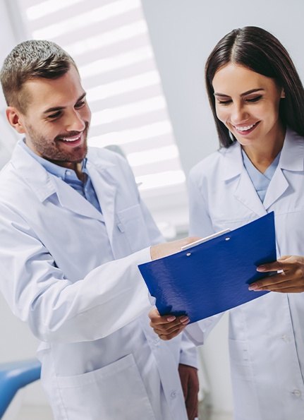 Dentists reviewing dental patient chart