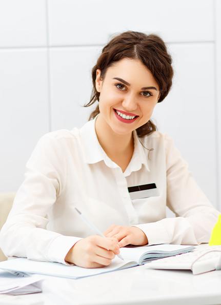 Dental office administrator reviewing patient paperwork