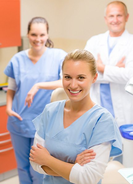 Three dental team members laughing together