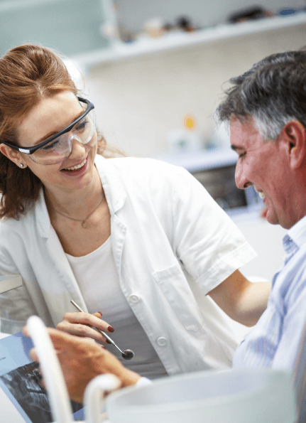 Dentist laughing with dental patient