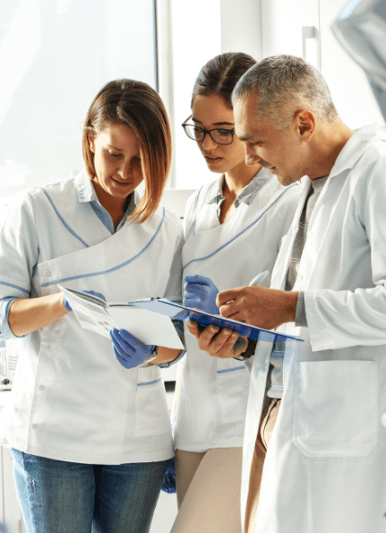 Dental team members reviewing patient charts